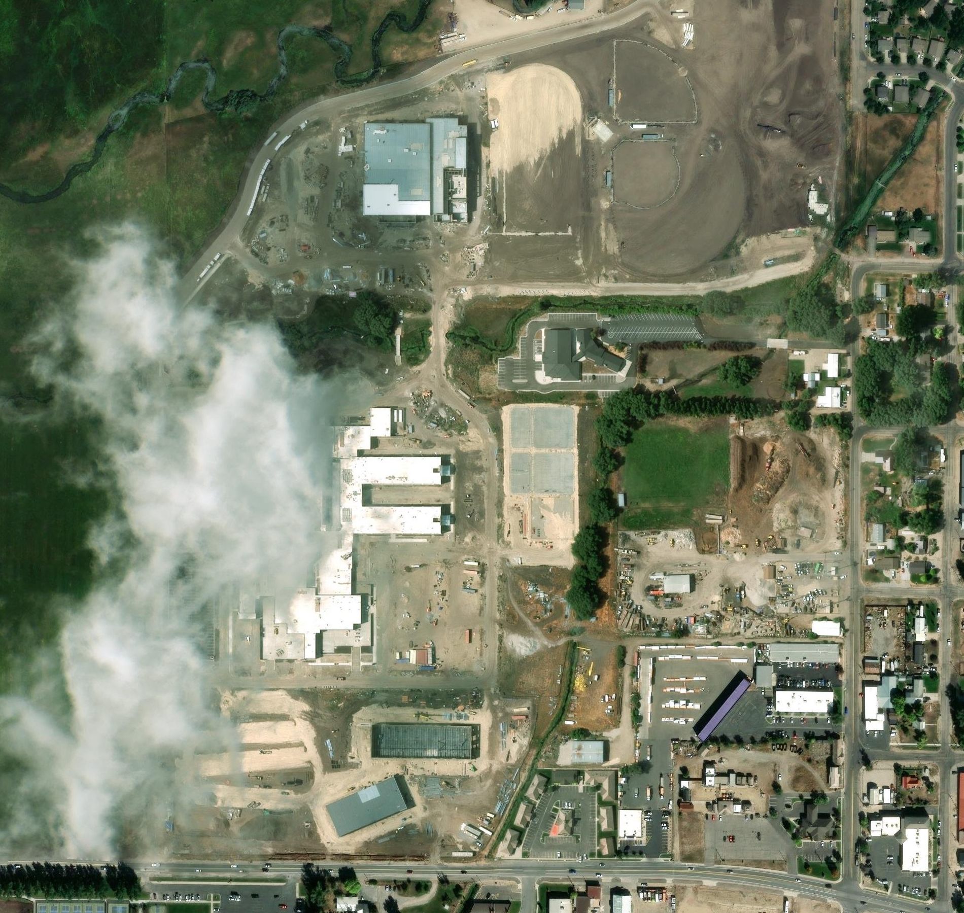 Satellite photo, July 2025: the campus nearly finished, with a cloud over the main building