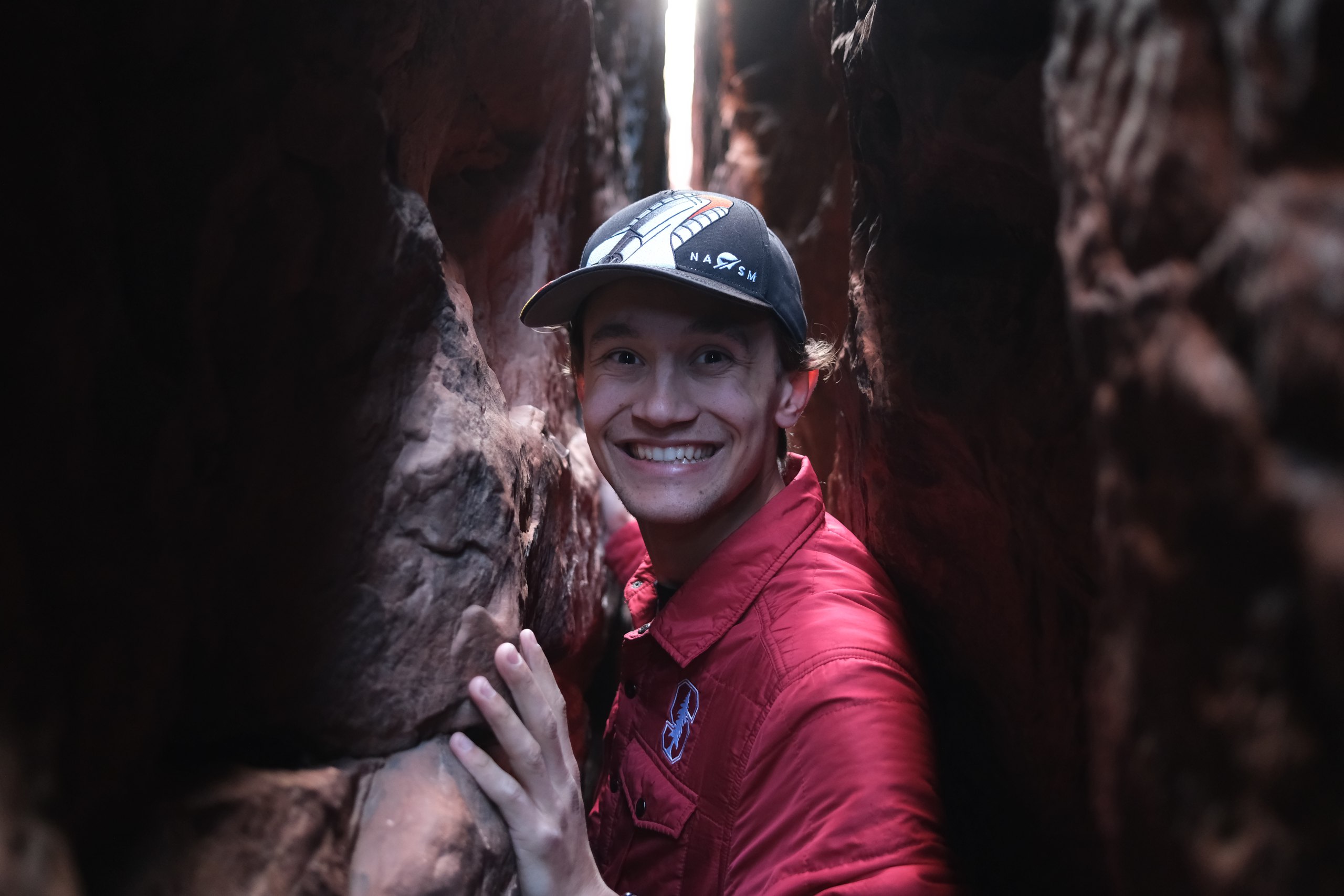 Ethan smiling in a red-rock slot canyon