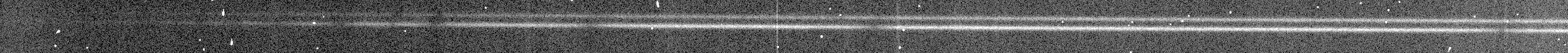 A raw spectrum frame: two faint horizontal streaks, the pulsar's companion and a neighboring star, across a dark field speckled with cosmic rays