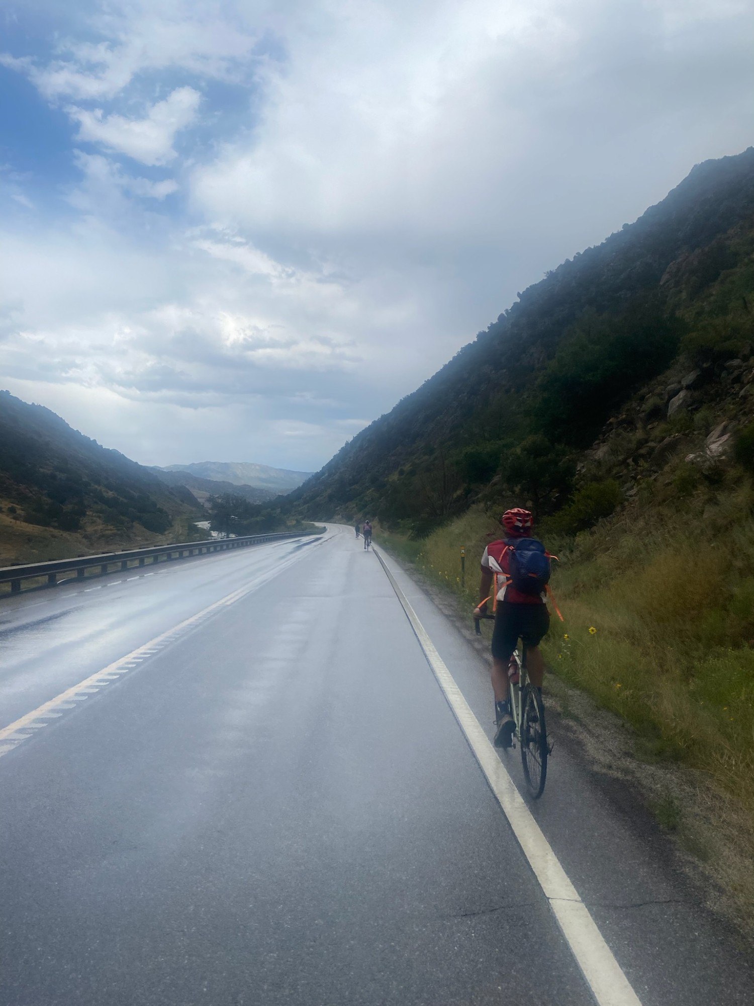 Spokes riders on a wet canyon road