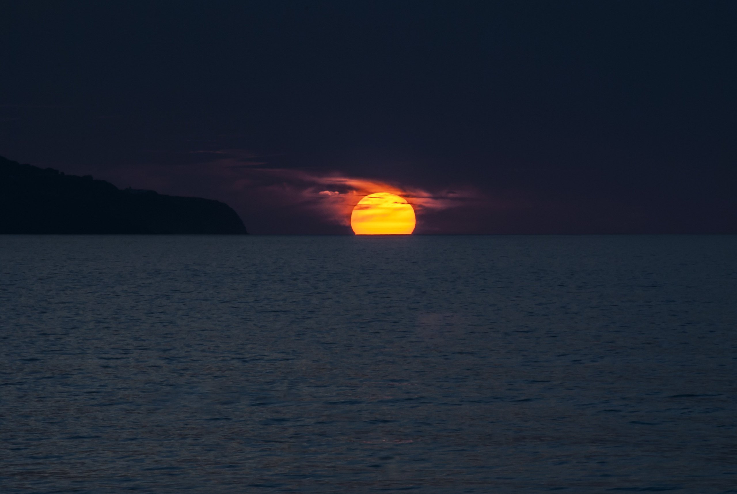 The sun setting into the ocean